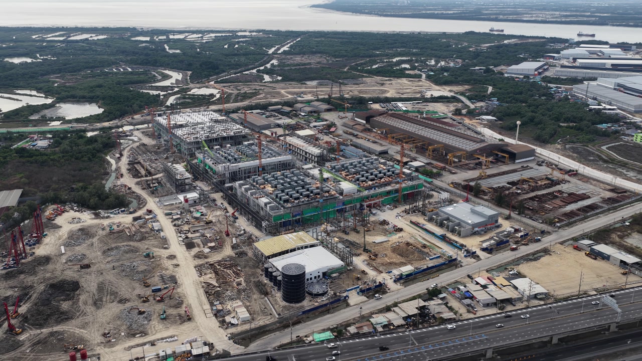 Aerial drone video of Data Centre QHI01 hyperscale campus construction in Chonburi, Thailand, within the Eastern Economic Corridor, showing large scale cloud computing, AI infrastructure, and