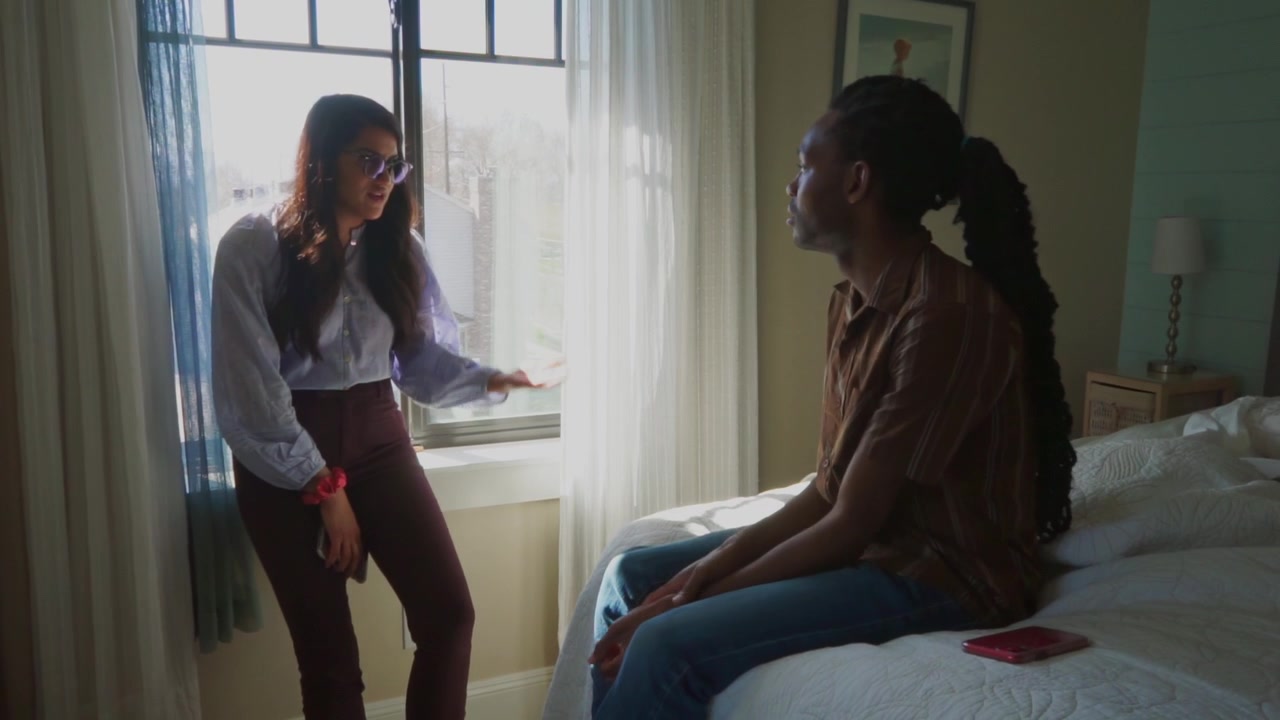 shot of movie talents talking to each other in the bedroom in front of the window