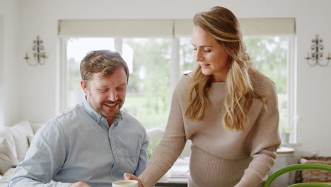 couple with pregnant wife reviewing domestic finances together