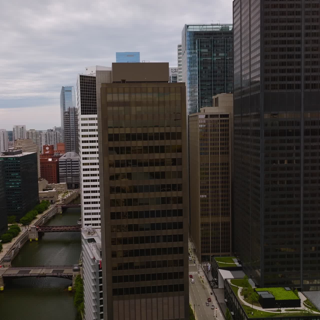 Multi-lane road and Chicago River going between the beautiful buildings. Stunning architecture of metropolis at dull weather day