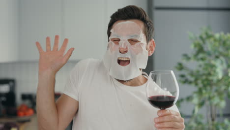 man with a face mask and wine
