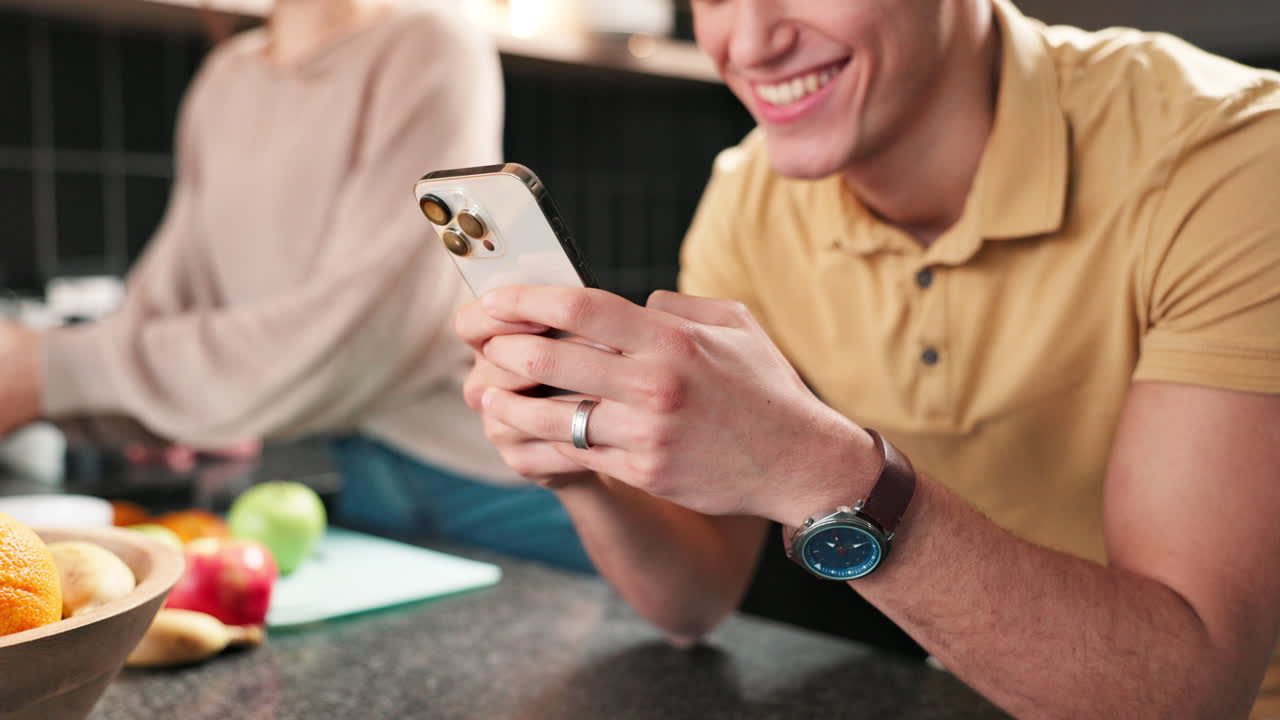 People in kitchen using a phone