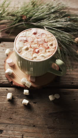 vertical video of mug of chocolate, marshmallows and copy space on wooden background