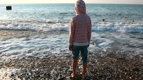 junge am strand bei sonnenuntergang