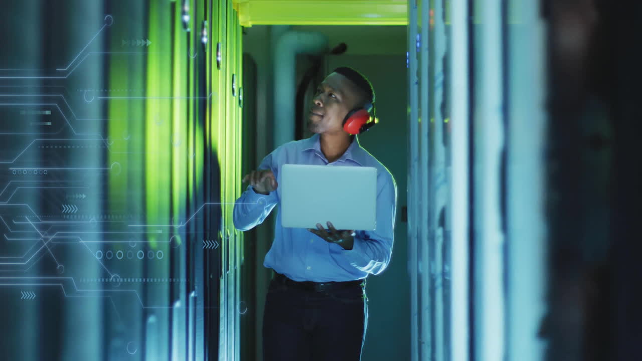 Animation of data processing and african american male it technician with laptop by computer servers