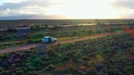 orbiting aerial view of a car in the middle of australian outback in in victoria near port augusta