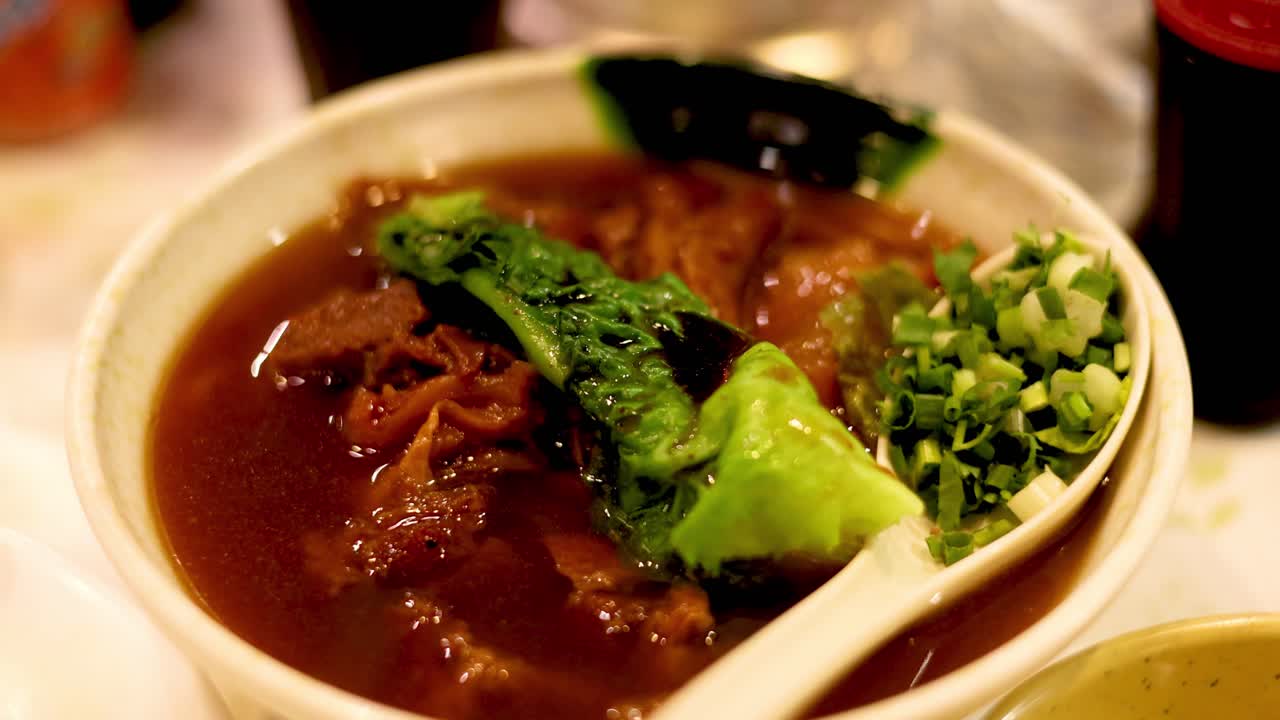 Savory beef stew noodles with fresh greens