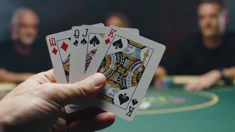 intense poker showdown: a hand revealed in a high-stakes game with focused players at the table engaging in strategy and bluffing