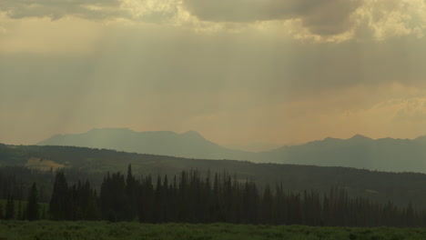 light shadow on a cloudy sky over mountains during rainstorm. timelapse