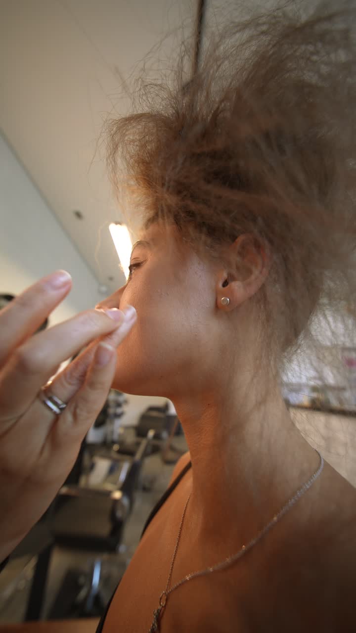 Young Woman Getting Makeup Applied in a Salon