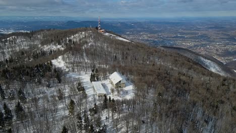 aerial 4k drone footage of a old abandoned millitary complex on the top of the mountain in the winter time