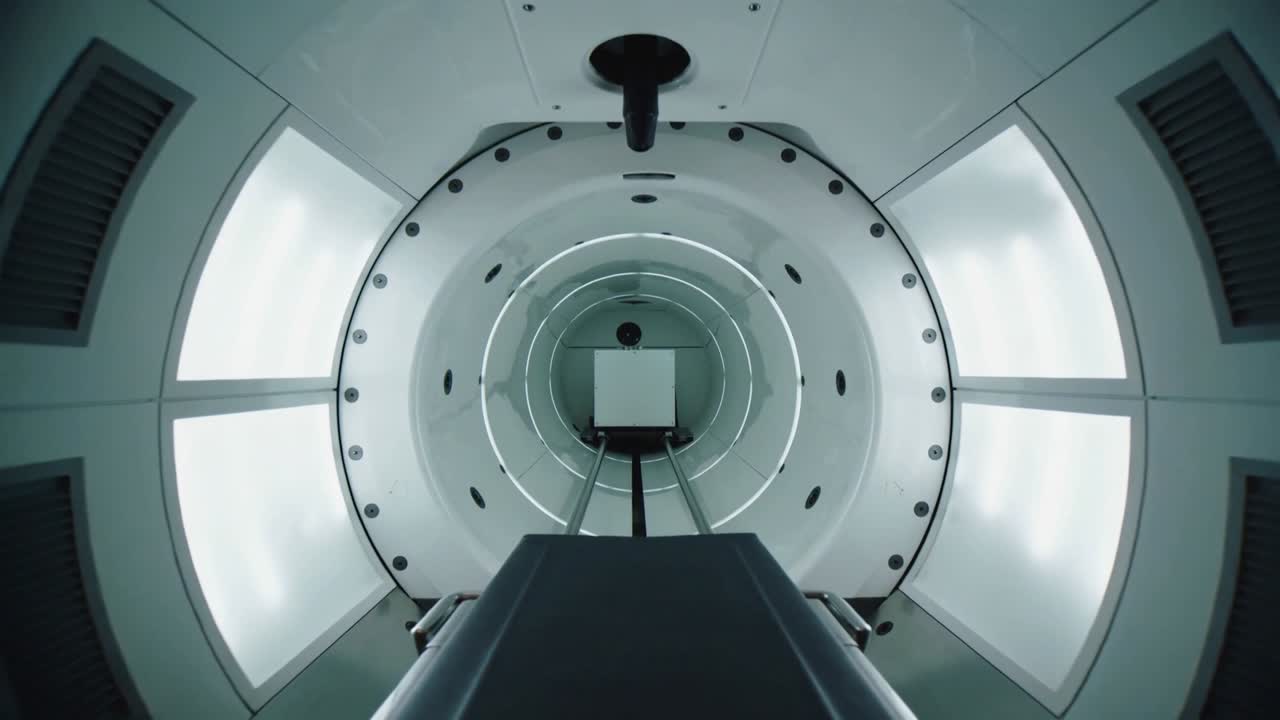 Moving scanner after scan start pushing gurney into radiology bore, showing head coil and LEDs