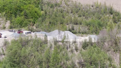 trucks in quarry ready to be loaded with crushed stone, aerial view