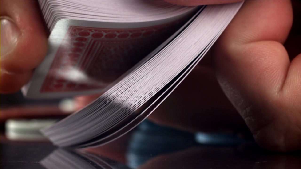 Close-up of Hands Shuffling a Deck of Playing Cards