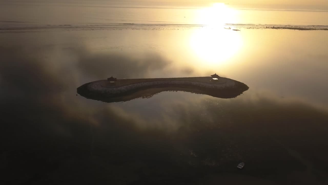Højvinkeloptagelse af stranden i Sanur, Bali ved solopgang.