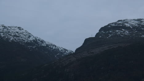 tracking shot from the ship on the mountain side in hardanger, hardangerfjorden in early morning