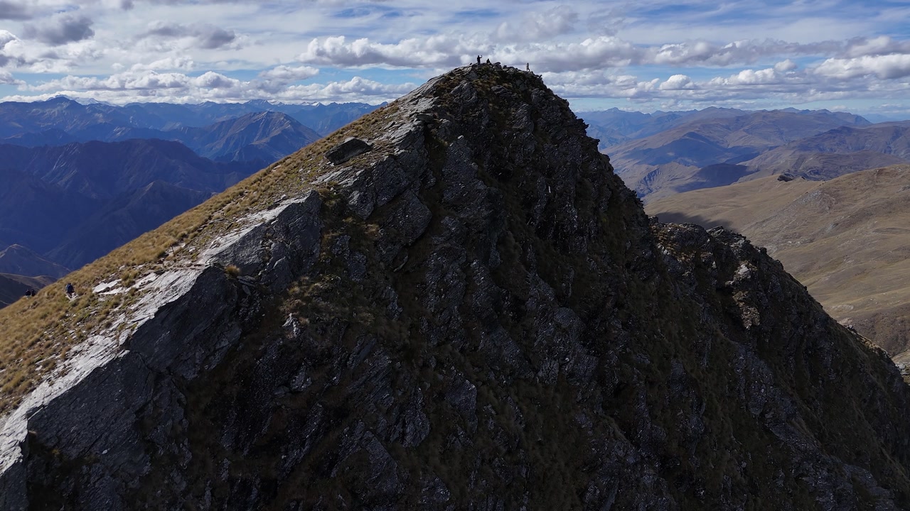 Aerial flight to tourists on Ben Lomond mountain summit in New Zealand