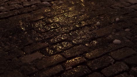 close up of cobble stones in soho new york as they shimmer during early morning snowfall