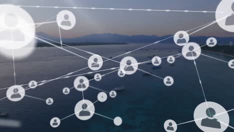 Animation-of-network-of-profile-icons-against-aerial-view-of-the-sea