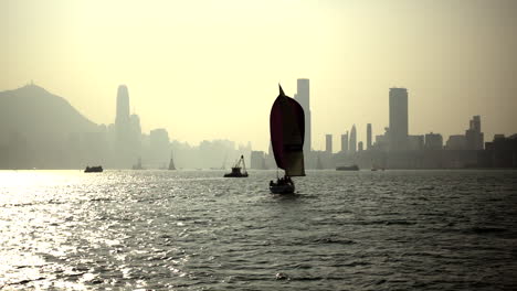 wooden boat flowing at hong kong victoria harbour in slow motion
