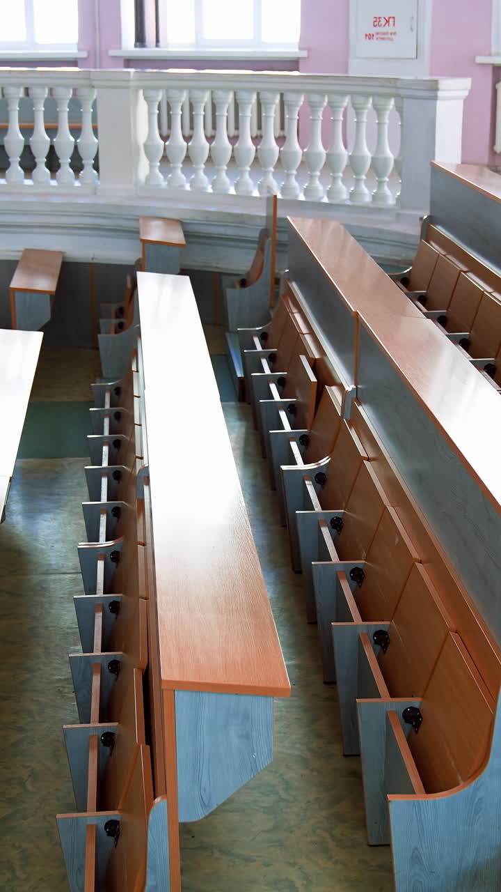 Empty lecture hall in university. Interior of contemporary lecture theater in university campus. Vertical video