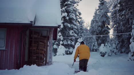 Caucasian-Man-Is-Removing-Thick-Snow-Using-Sleigh-Shovel