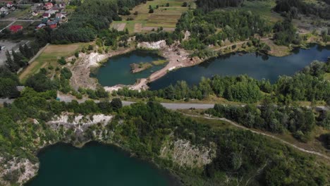 aerial view of road running through lakes surrounded by nature