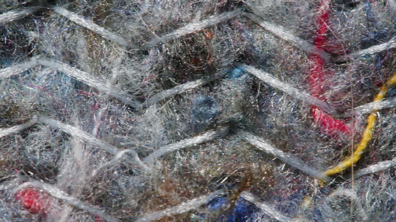 Close-up of a woven textile with various colored threads