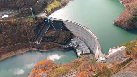 explore the engineering marvel of a japanese river dam with this captivating 4k aerial footage.