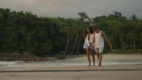 couple holding hands at sunset