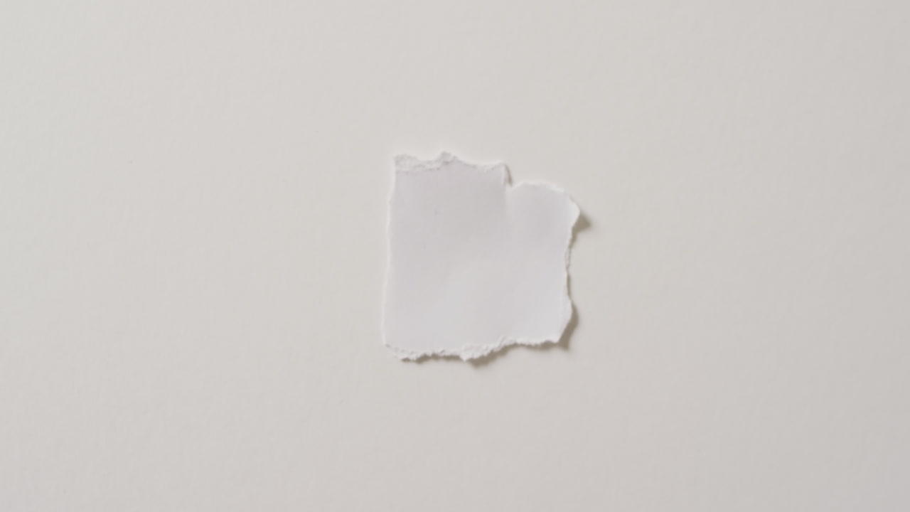Video of close up of torn piece of paper with copy space on white background
