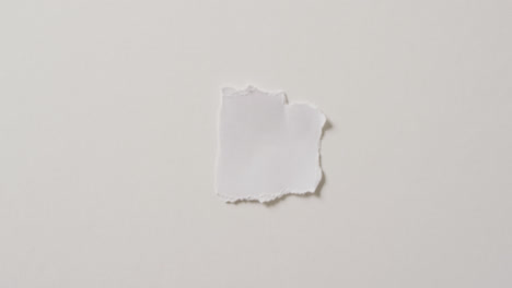 video of close up of torn piece of paper with copy space on white background