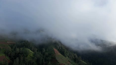 Active-Merapi-volcano-hiding-in-clouds-in-Indonesia,-aerial-view