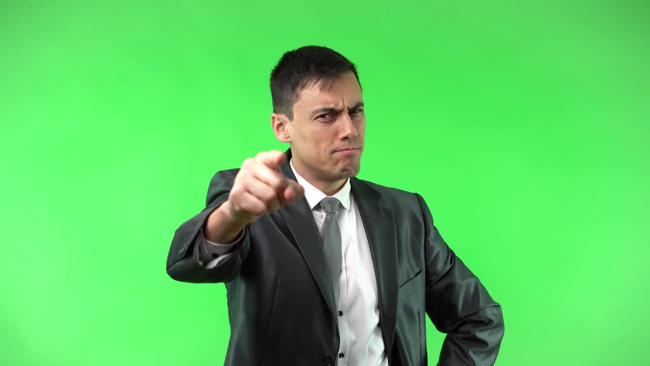 Man in Suit Pointing on Green Screen