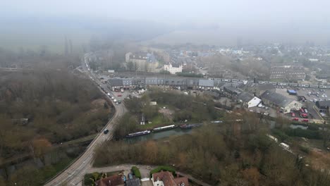 Sawbridgeworth-railway-station-and-canal-boats-moored-train-moving-into-shot-Essex-UK-Aerial-footage