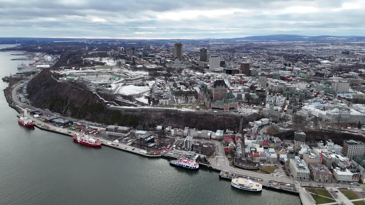 Panoramic aerial view of Quebec City's historic district and waterfront on a cloudy day, showcasing the city's unique blend of history and modern urban life, Canada