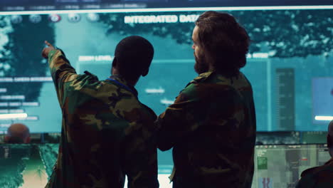 diverse team of military personnel examining gathered information