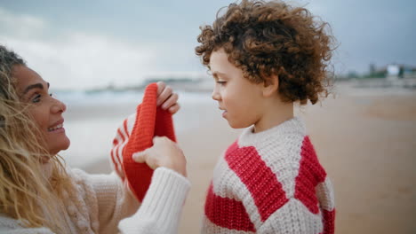 El-Padre-Puso-Un-Gorro-En-El-Primer-Plano-De-Su-Pequeño-Hijo.-Joven-Y-Hermosa-Madre-Cuidando