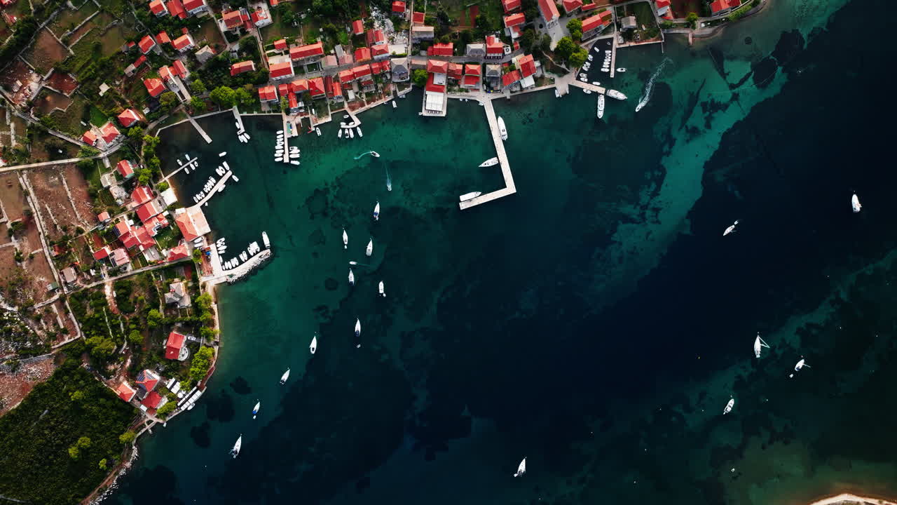 Drone top down bird's eye view of Ilovik island Croatia and coastline village homes
