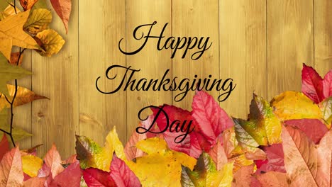 Animation-of-happy-thanksgiving-day-text-over-autumn-leaves-and-wooden-surface