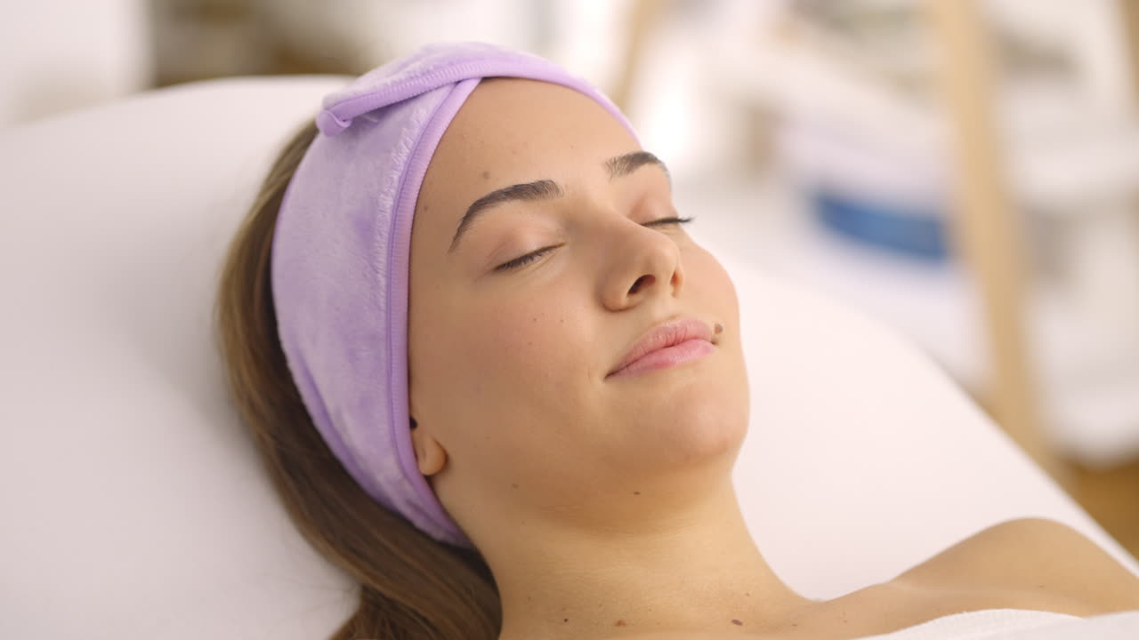 Woman relaxing during a facial treatment