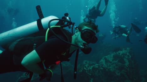scuba divers exploring the deep blue ocean