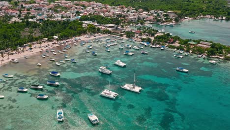 boats moored in transparent waters of bayahibe tourist port, la romana in dominican republic