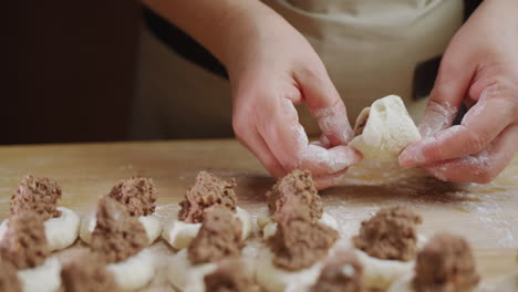 a professional baker makes dumplings with meat filling. delicious traditional ukrainian cuisine