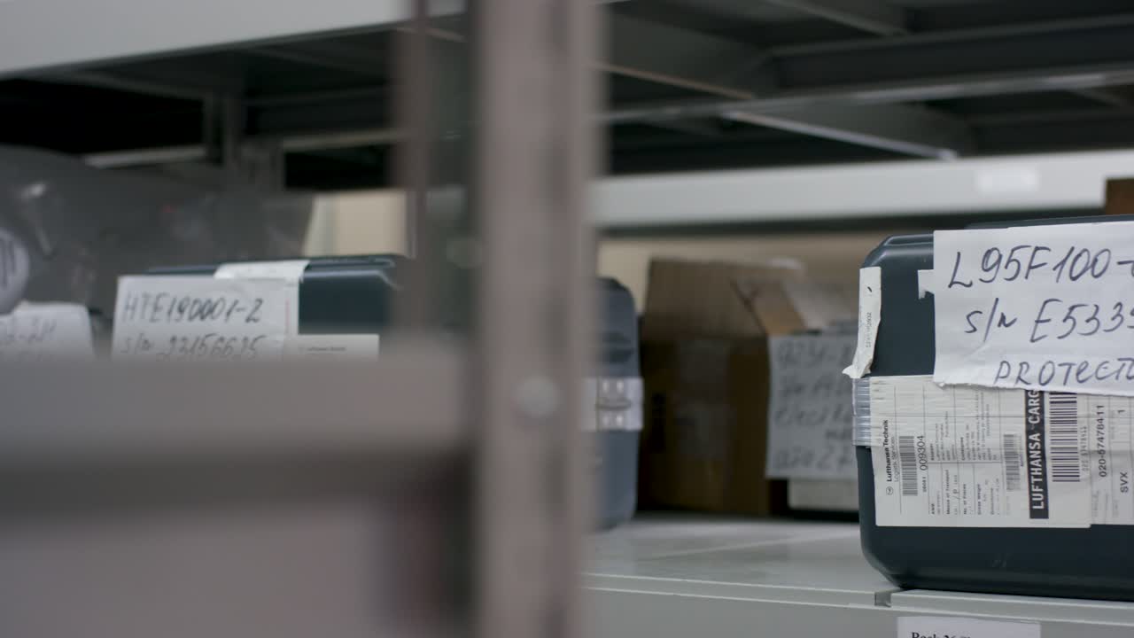 Woman Handling Containers in Warehouse