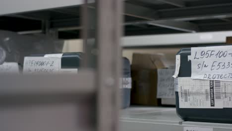 woman handling containers in warehouse