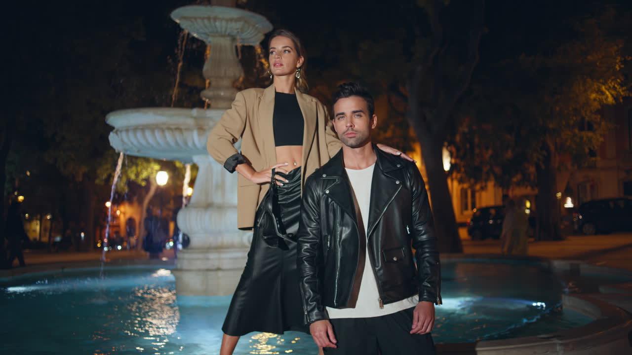 семейная пара позирует на улице в крутом наряде. уверенные в себе сексуальные модели стоят в городе