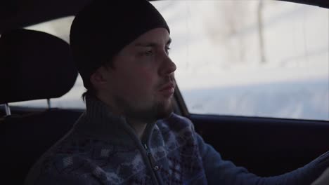 hombre conduciendo un coche en invierno