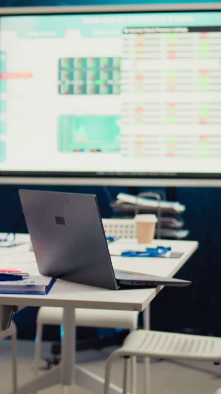 Modern Office Workspace with Laptop and Business Data on Screen