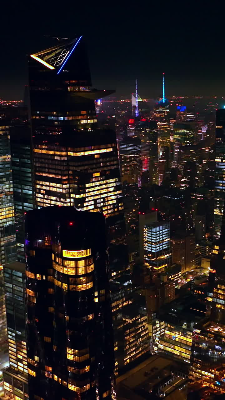 Multiple lights reflecting in the mirror windows of famous New York skyscrapers. Endless cityscape of stunning metropolis. Aerial view. Vertical video